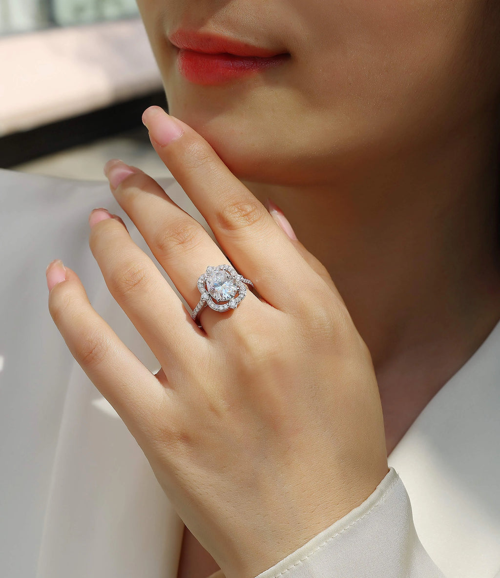 Egg-shaped moissanite ring set with S925 silver and platinum plating on a white surface