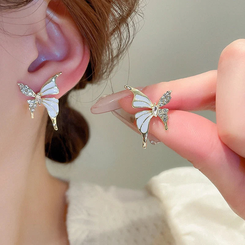 Rhinestone-dripped butterfly stud earrings in alloy with diamond treatment, available in colors A128 and A129