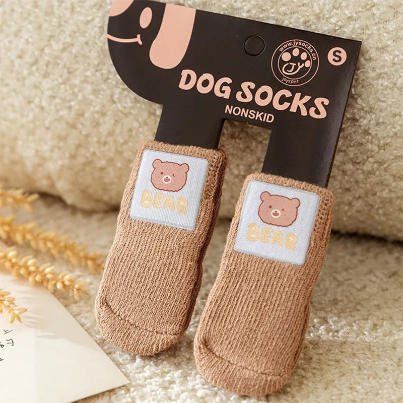 Dog all-season universal cotton socks with cute big eyes, anti-slip sole, green colour, side view on wooden floor