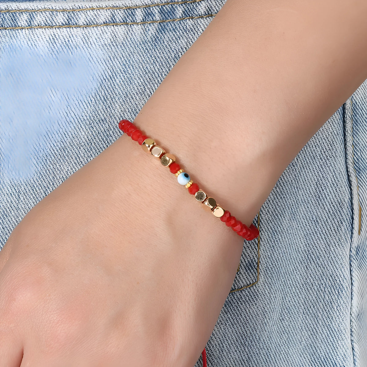 Red hand-woven beaded couple bracelet with artificial crystal eye geometric design on white background