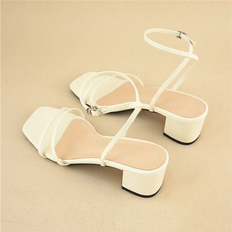 Beige women's stiletto sandals with a chunky block heel and an adjustable ankle buckle strap.