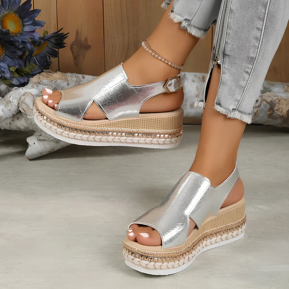 Women's gold fish mouth buckle wedges with hollow sides and 7 cm rubber heel on white background