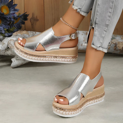 Women's gold fish mouth buckle wedges with hollow sides and 7 cm rubber heel on white background