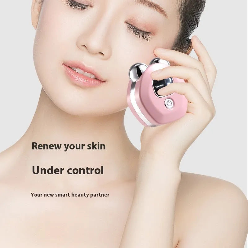 Portable white micro current double-roller facial massage instrument with hot compress function and USB charging cable.