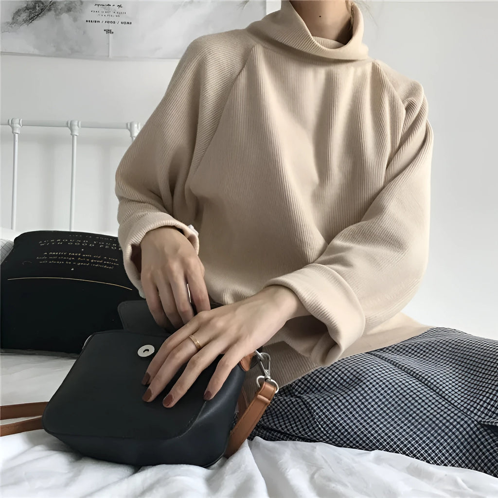 Women's solid colour long sleeve top with a half-high collar in a loose fit, shown in apricot.