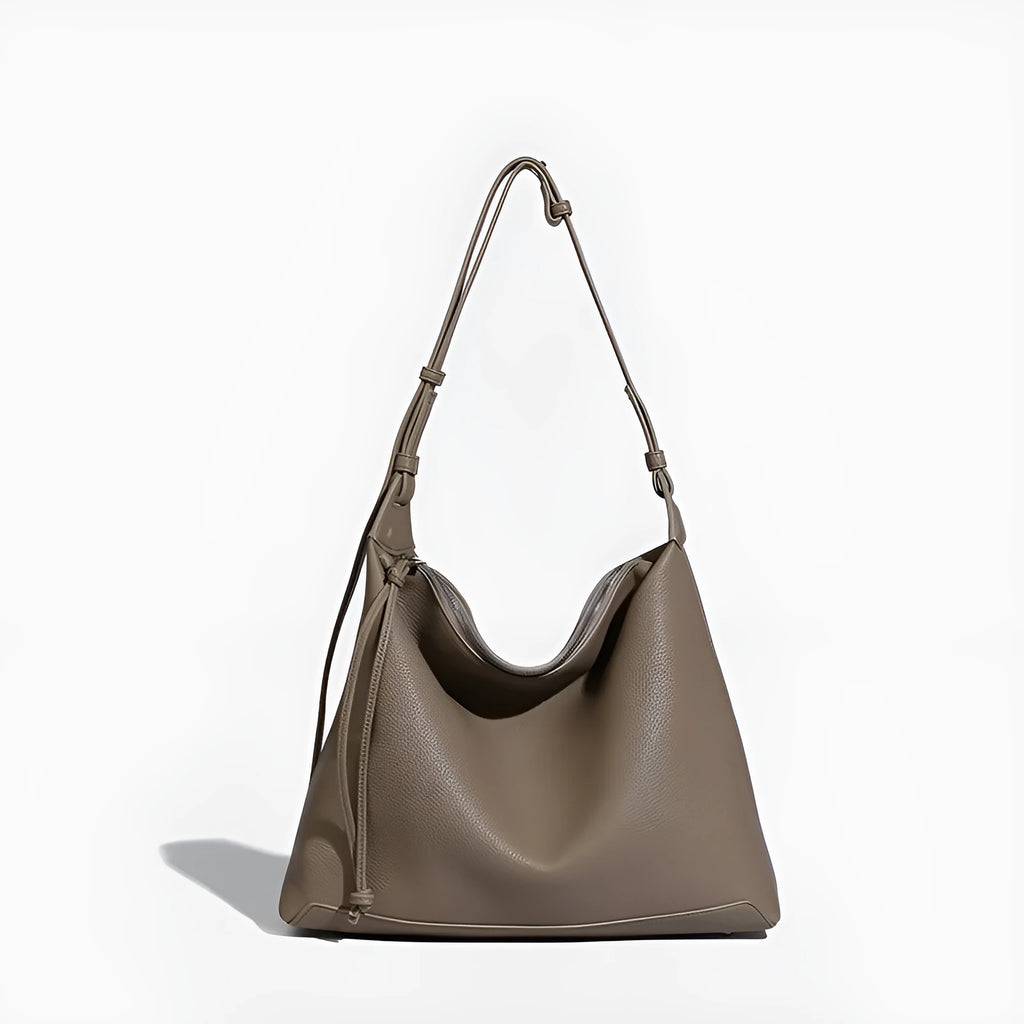 Large soft PU messenger bag in caramel colour showing shoulder strap and dimensions