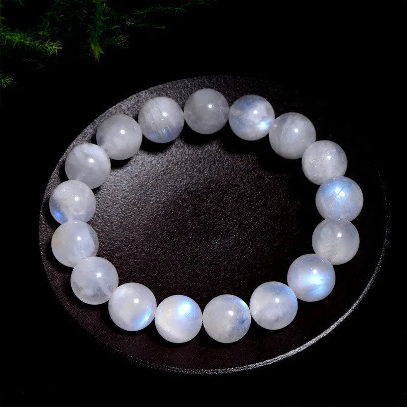 Natural blue moonlight round bead moonstone bracelet in white, showing polished stone surface.