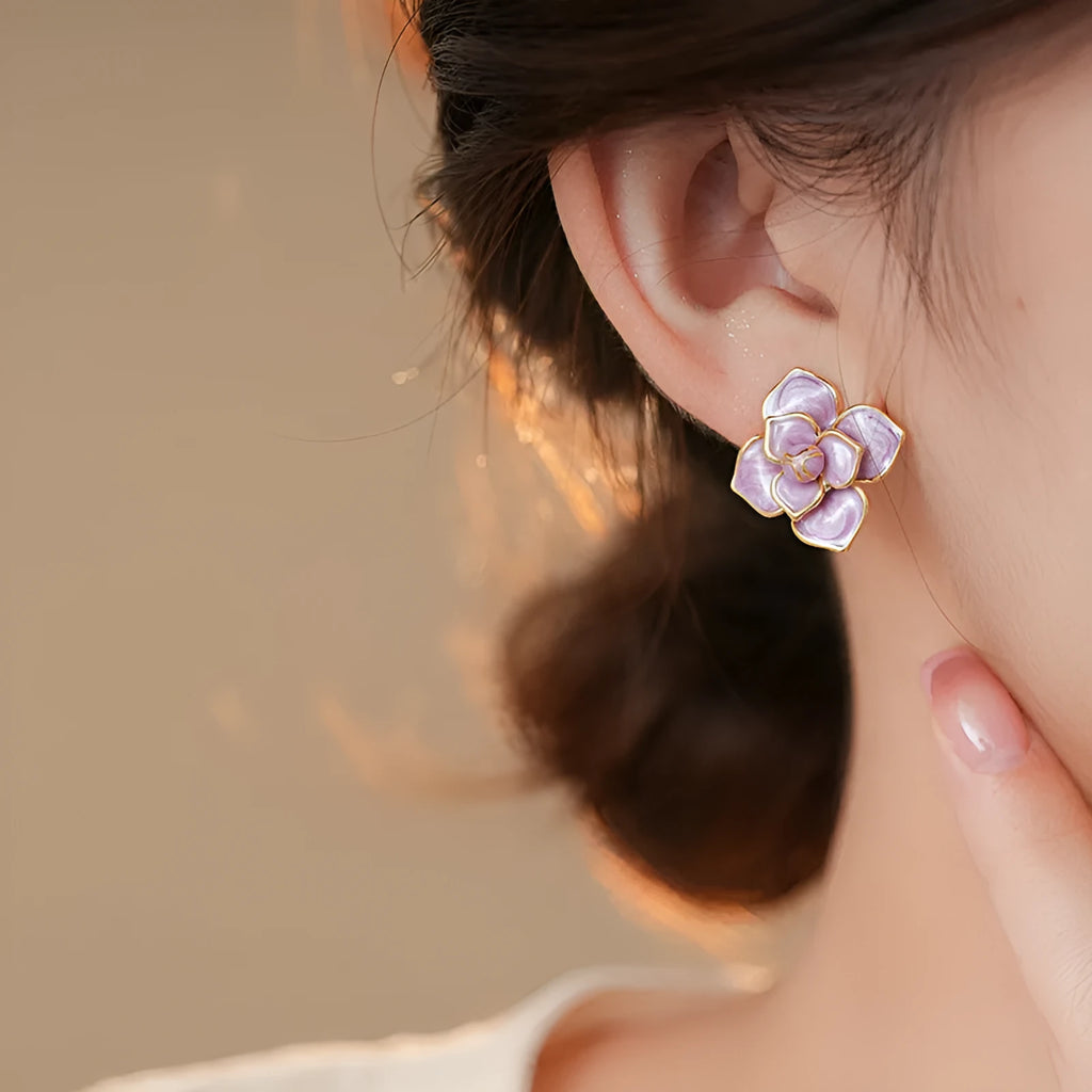 Gold-plated purple oil-spot glaze floral stud earrings on a copper base.