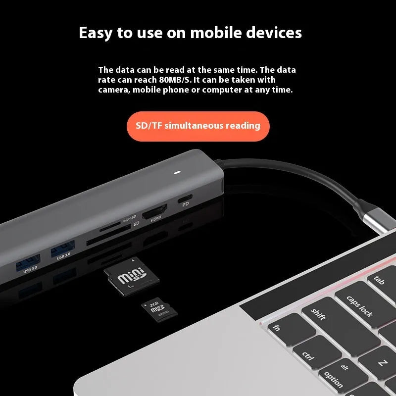 Silver aluminium 7-in-1 USB-C hub with SD card slot, microSD slot, USB-A, and USB-C ports.