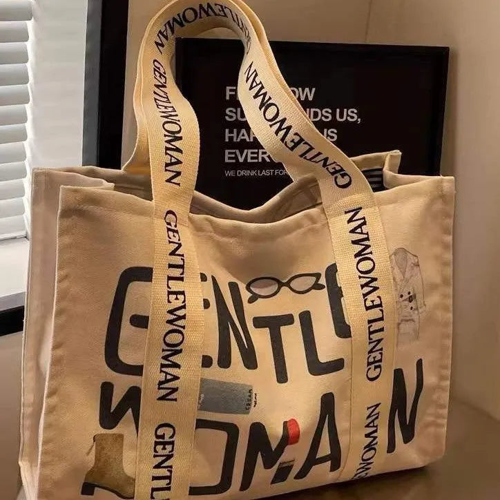 Large canvas women's tote shopping bag with printed design in choice of black letters, coloured letters, or pattern style.