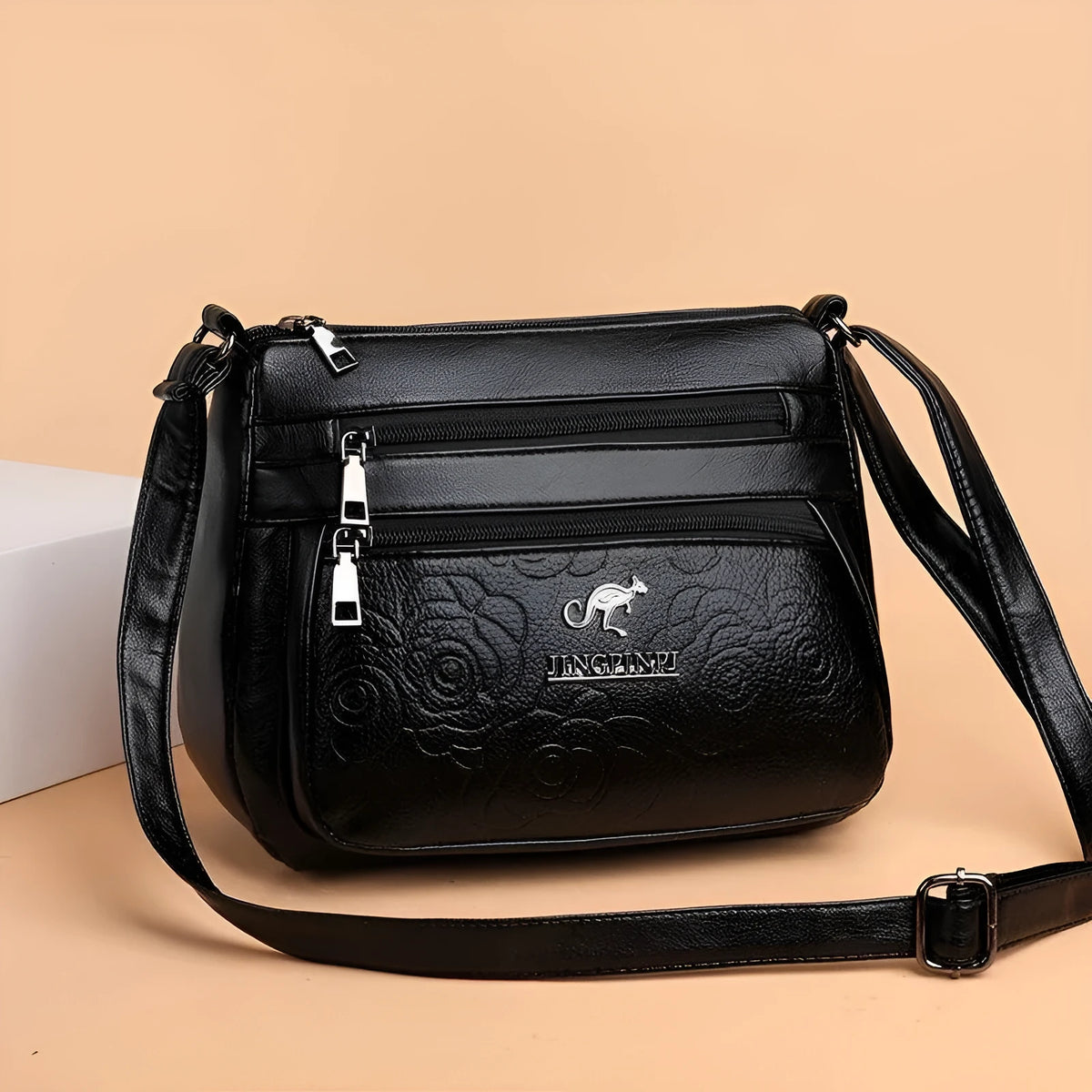 Women's black PU leather messenger bag with embossing and sewing thread details, horizontal square shape, single shoulder strap