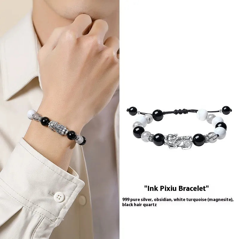 Sterling silver blessing card attached to a hand-woven black and white couple bracelet set with tassel details.