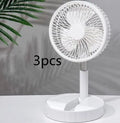 Black telescopic folding fan shown extended on a desk, with USB cable highlighting its phone charging function