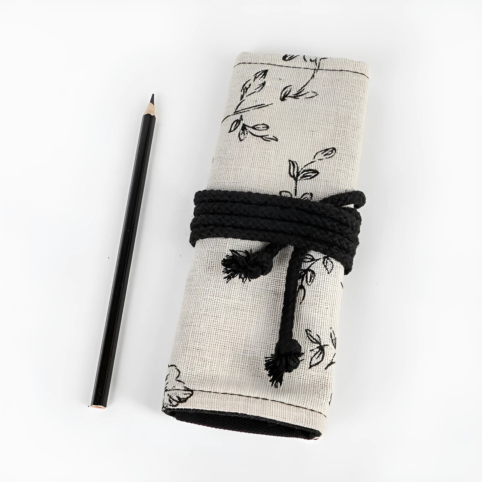 Black peony floral print pencil roll bag open to show multiple pencil slots.