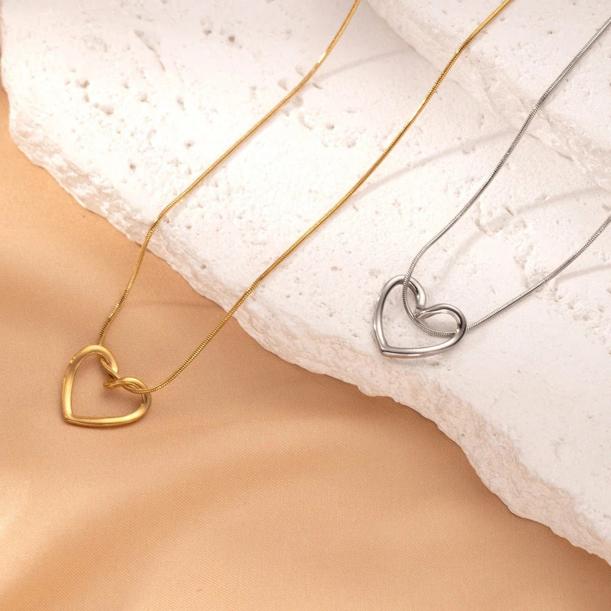 Stylish titanium steel twist pendant necklace with a hollow heart-shaped design, available in gold and silver colors