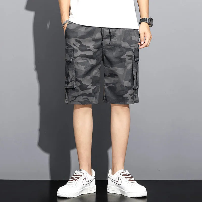 Men's camouflage 5-point workwear shorts in green, front view, with drawstring waist and mid-thigh length