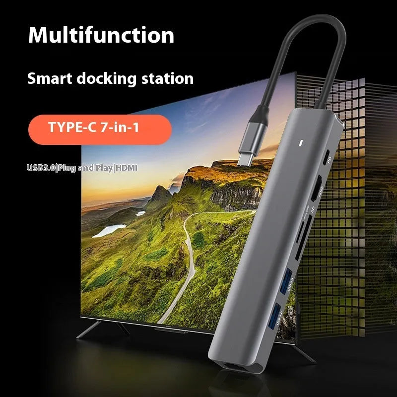 Silver aluminium 7-in-1 USB-C hub with SD card slot, microSD slot, USB-A, and USB-C ports.