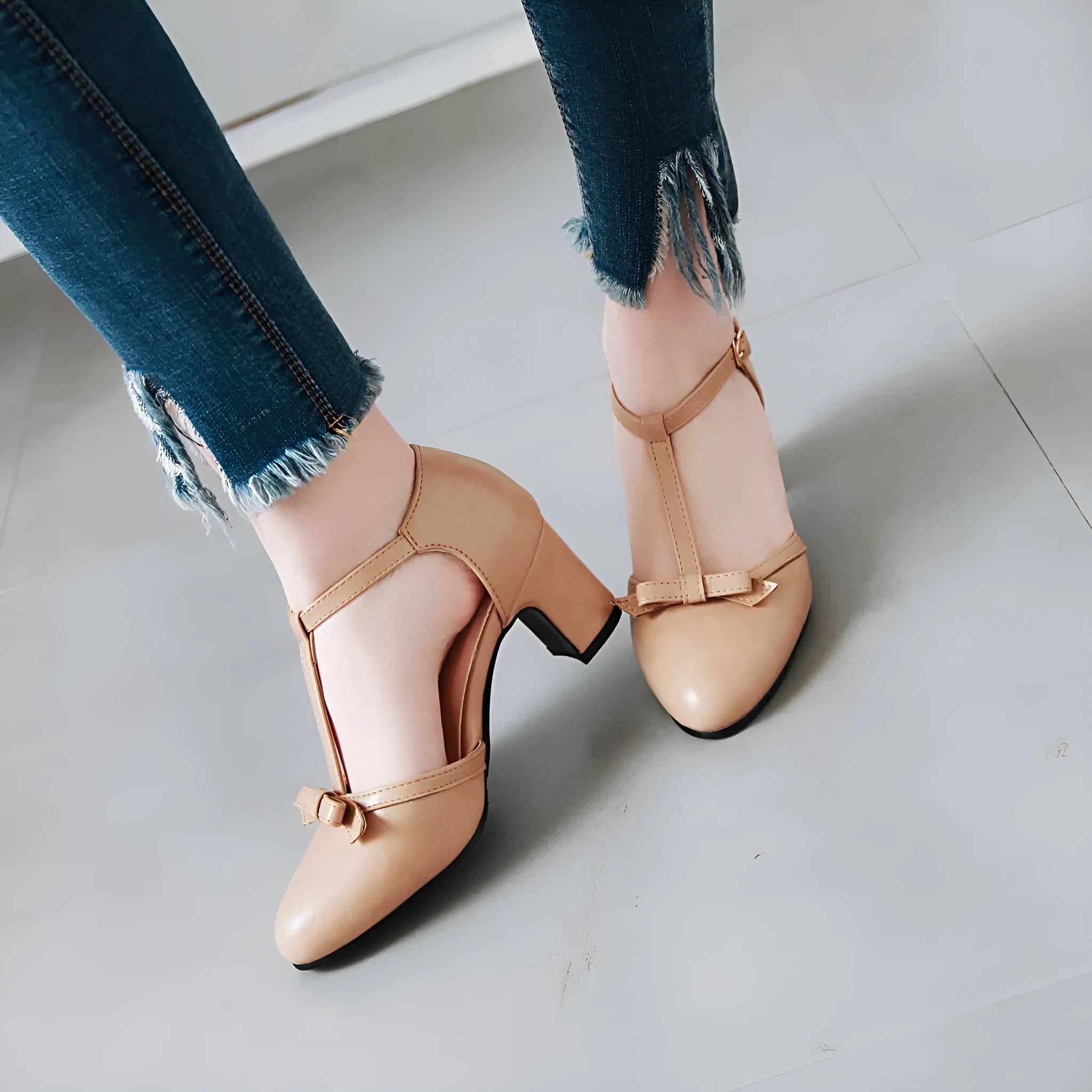 Women's apricot coloured chunky heel sandals with a bow detail and buckle strap on a 6.5cm heel.