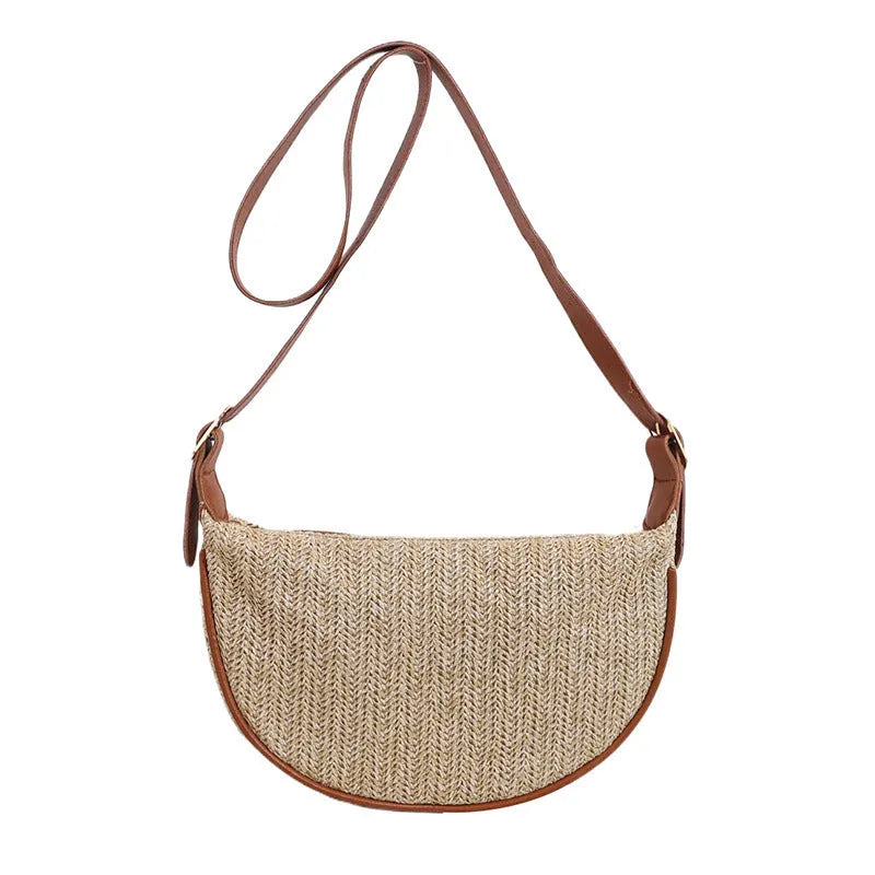 Women's woven straw crossbody bag showing textured surface and internal phone pocket