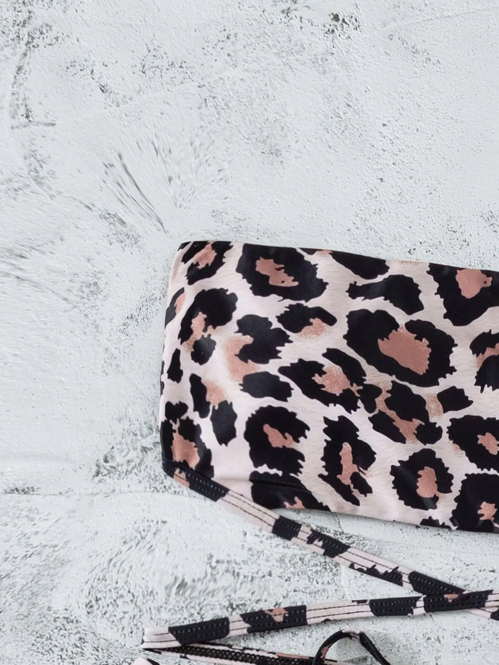 Leopard print bandeau split bikini swimsuit with removable chest pads on woman at beach