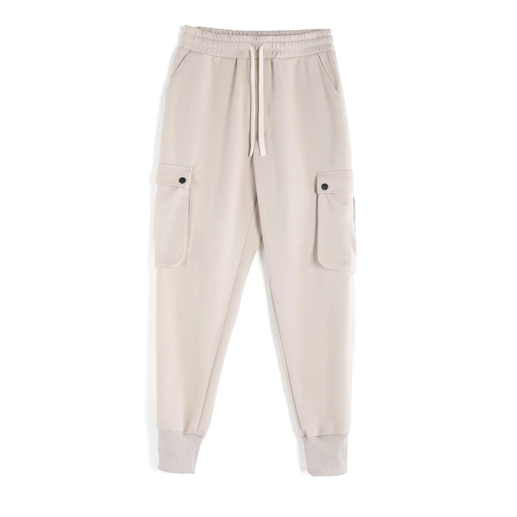 Men's loose-fit cotton sports trousers with ankle-tied cuffs and multiple pockets in a light grey colour.