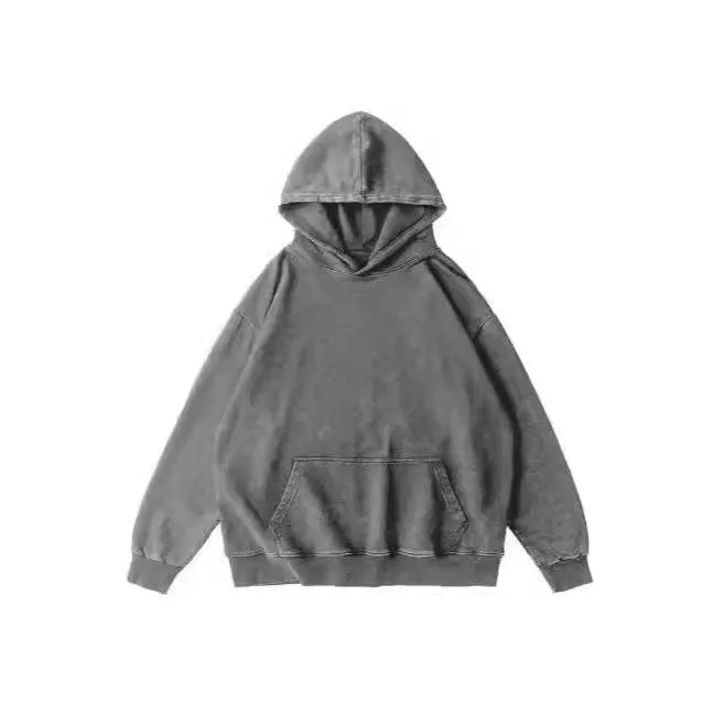 Man wearing a loose, brown, batik-washed cotton pullover hoodie with drop-shoulder sleeves.