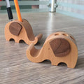 Beech wood and resin lazy phone holder bracket with decorative animal design holding a mobile phone.