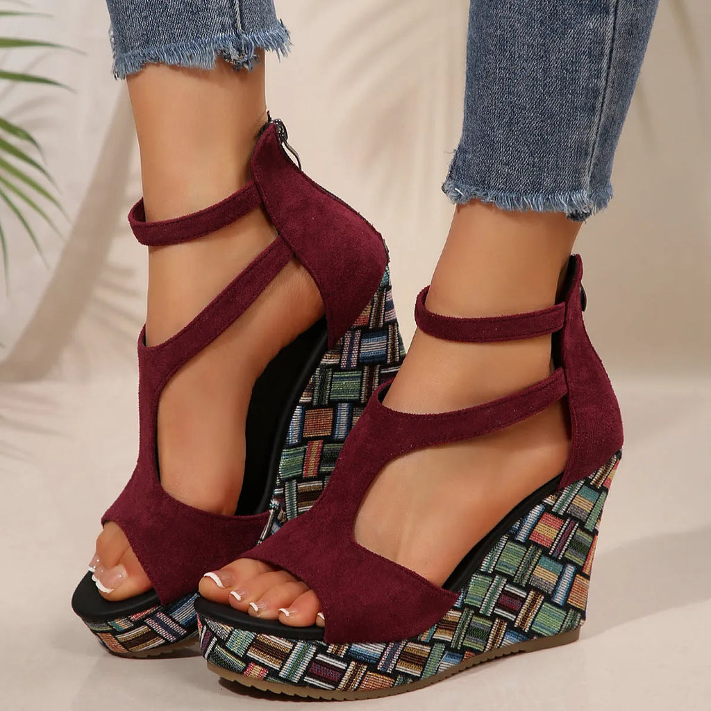 Women's beige wedge sandals with a thick rubber sole and buckle ankle strap on a cloth upper.