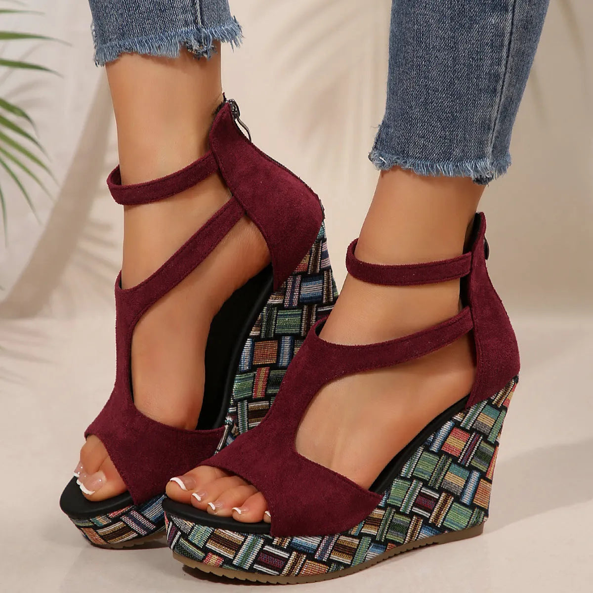 Women's beige wedge sandals with a thick rubber sole and buckle ankle strap on a cloth upper.
