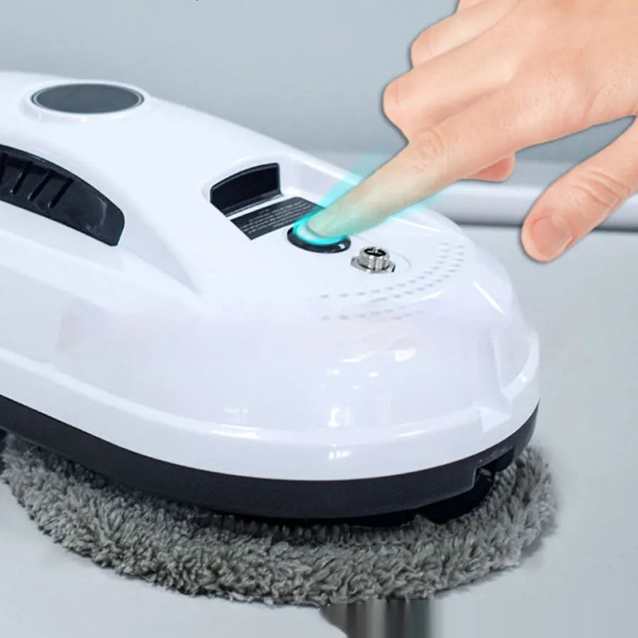 White automatic window cleaning robot HCR-02 with remote control, 28cm long, on a glass surface