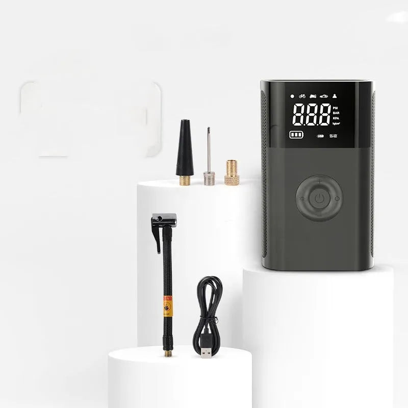 Handheld wireless digital tyre inflator with LCD screen and selection of nozzle adaptors.