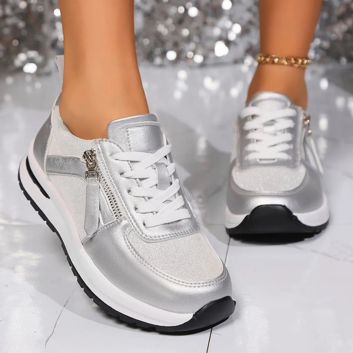 Gold women's flat lace-up pumps with round toe and shallow cut on a white background.