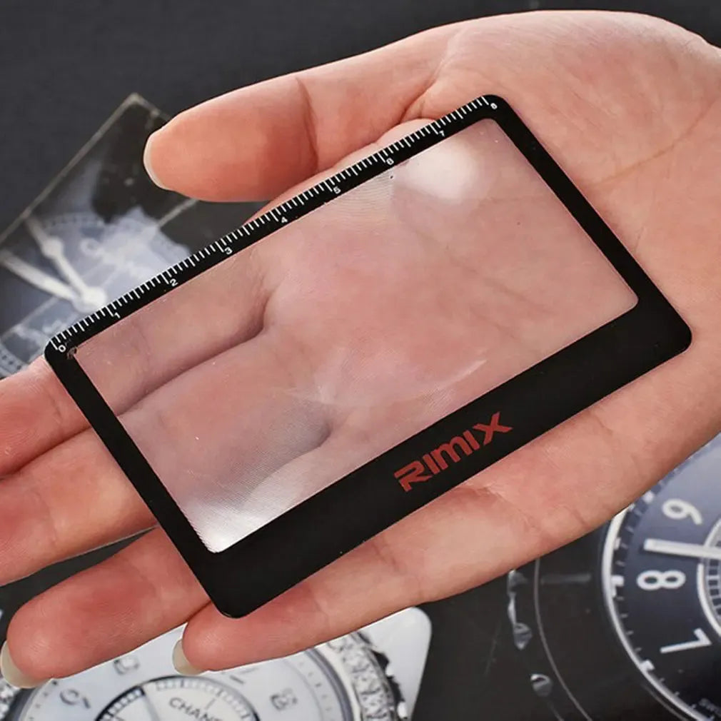 Black and white portable plastic card magnifier for reading and outdoor use.