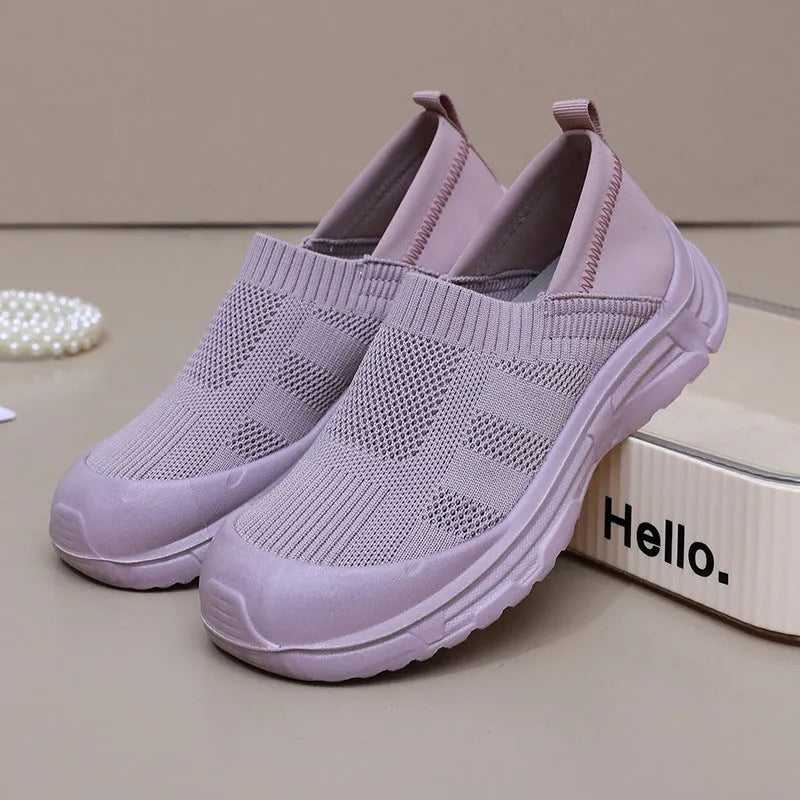 Women's black oversleeve shoes with round toe and soft flat PVC sole.