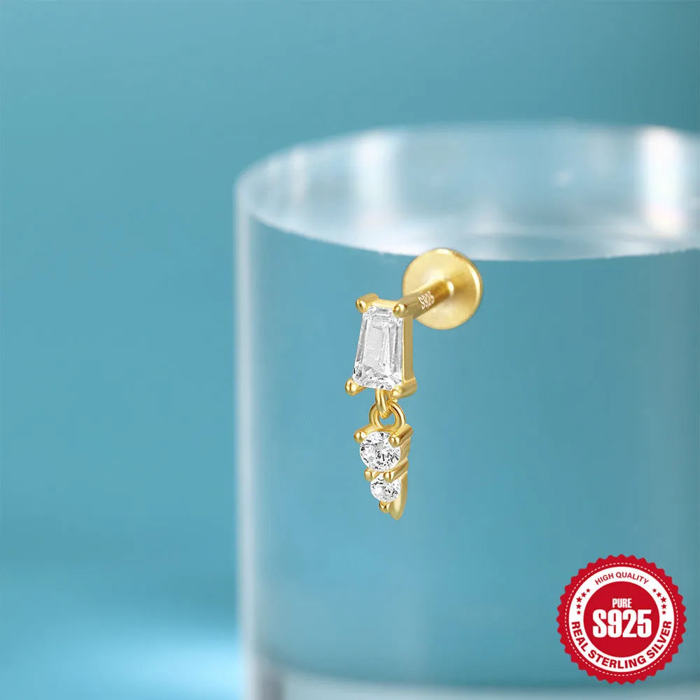 Sterling silver ear stud with a gold electroplated XINGX inlaid tassel design.