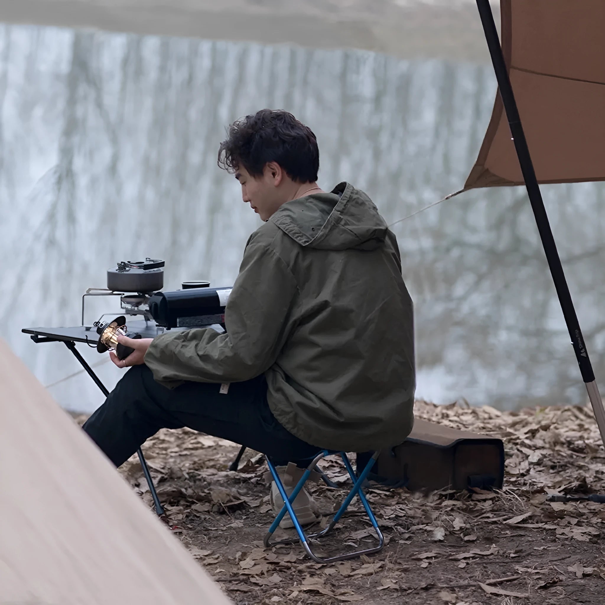Black aluminium alloy folding camping stool in a national style, shown in folded and open positions.