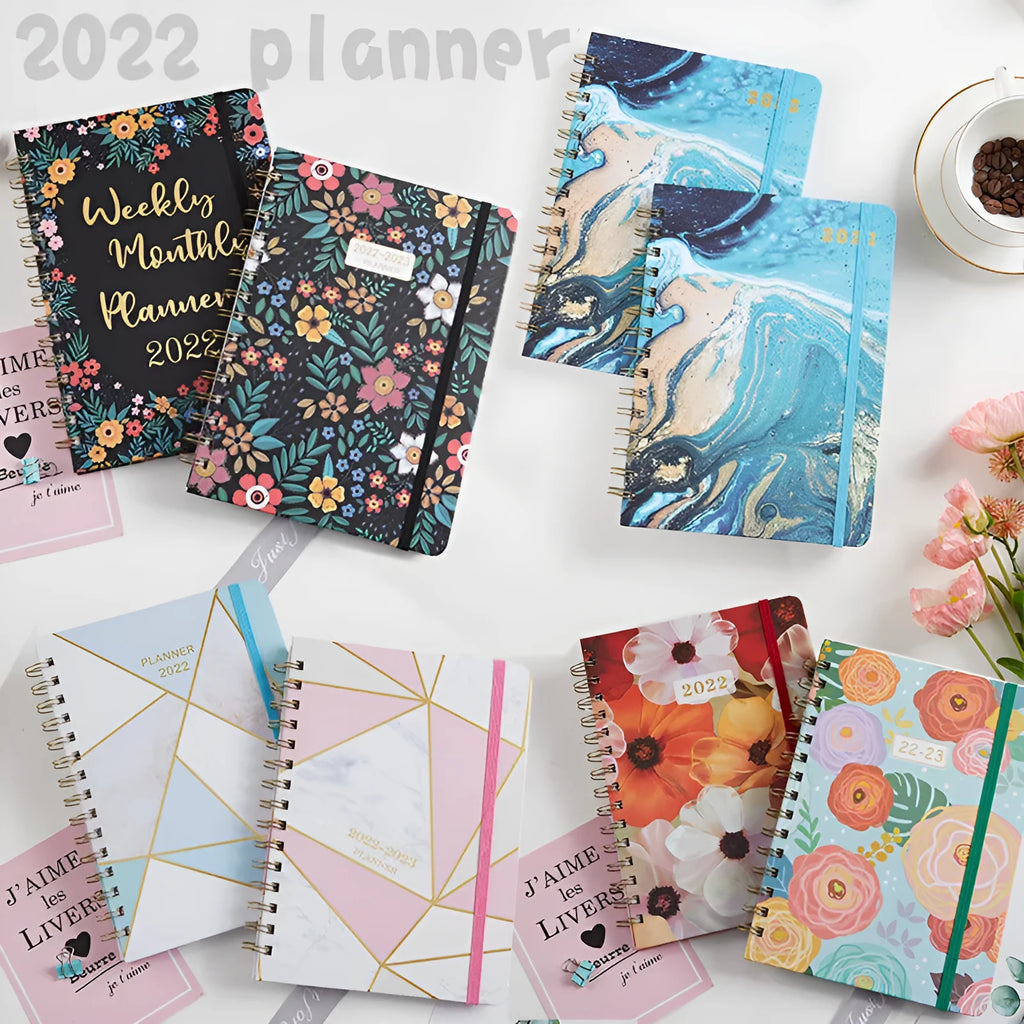 A5 spiral-bound notebook with a floral design cover, open to show 100gsm lined paper.