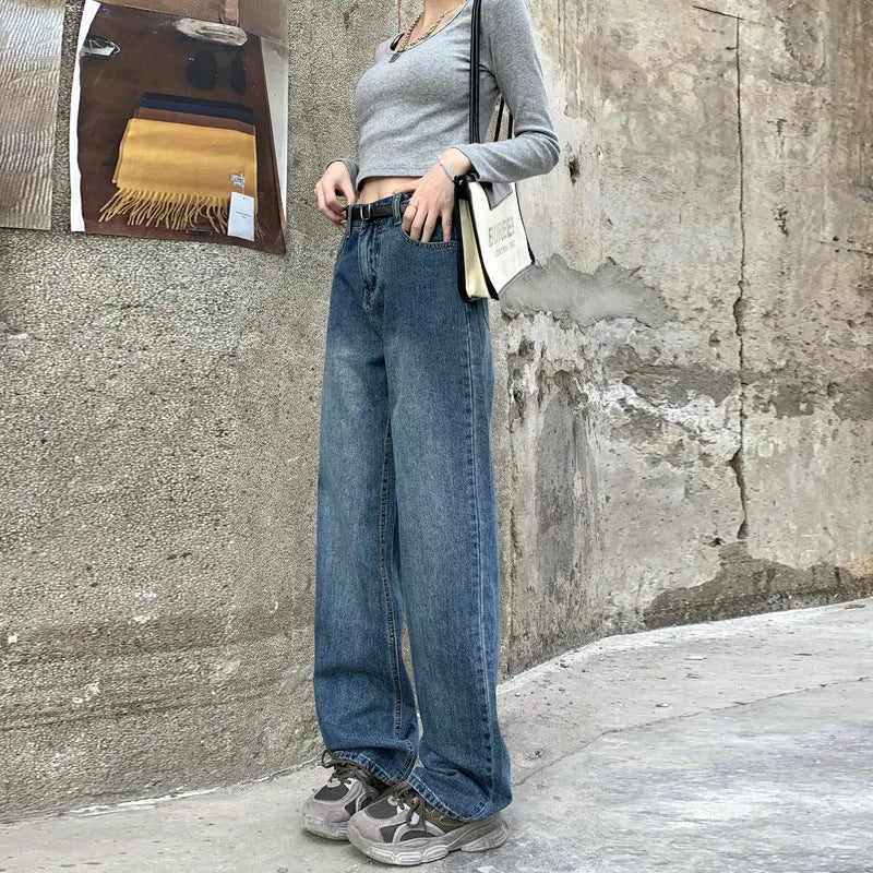Women's retro blue high waist straight leg jeans laid flat, showing the five-pocket design and button fly.