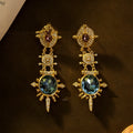 Gold alloy retro geometric round stud earring with diamond finish on white background