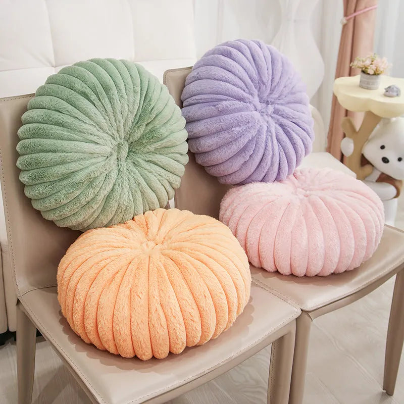 Pumpkin shaped seat cushion in khaki with short plush cover, 35x35x15cm, next to a window