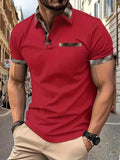 Man wearing a loose fit short sleeve t-shirt with a red and black plaid colourblock design.