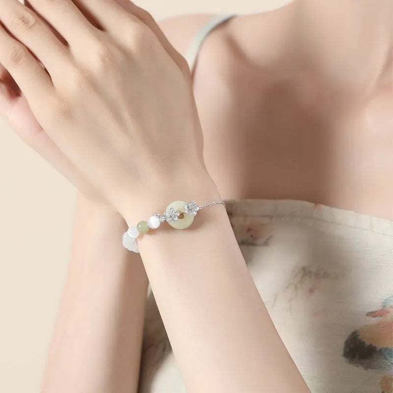 Pure silver women's bracelet with peach blossom design and safety buckle closure in white gold colour