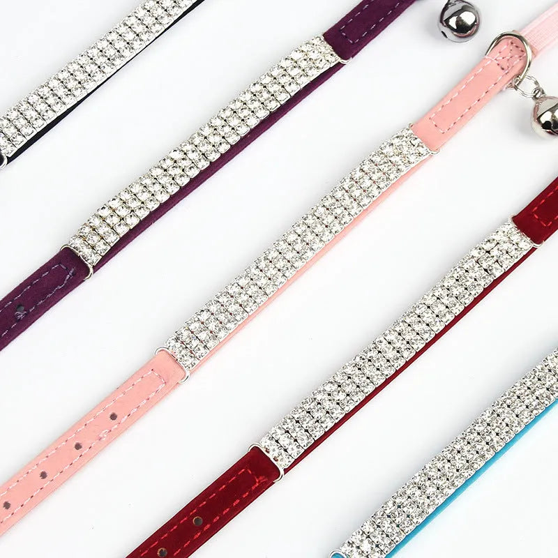 Adjustable velvet cat collar with rhinestone decoration in red, shown on a white background.