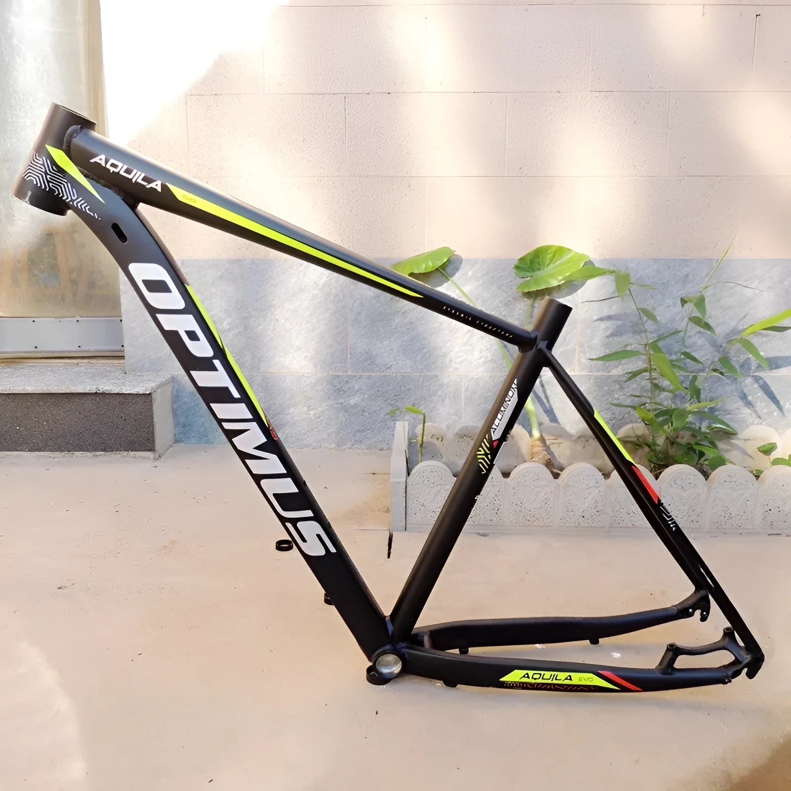 Black green 29 inch aluminium mountain bike frame showing internal cable routing ports and disc brake mount.