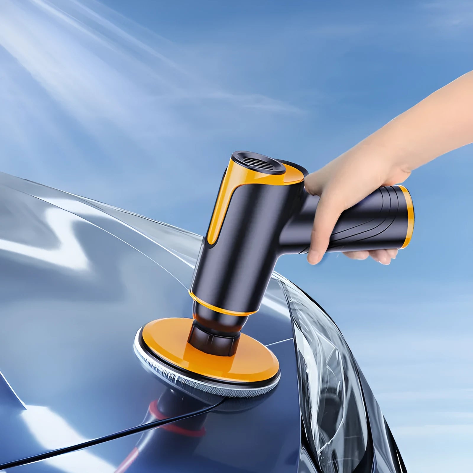 Cordless car polishing machine with black ABS body, orange waxing pad, and 12cm disc on a table