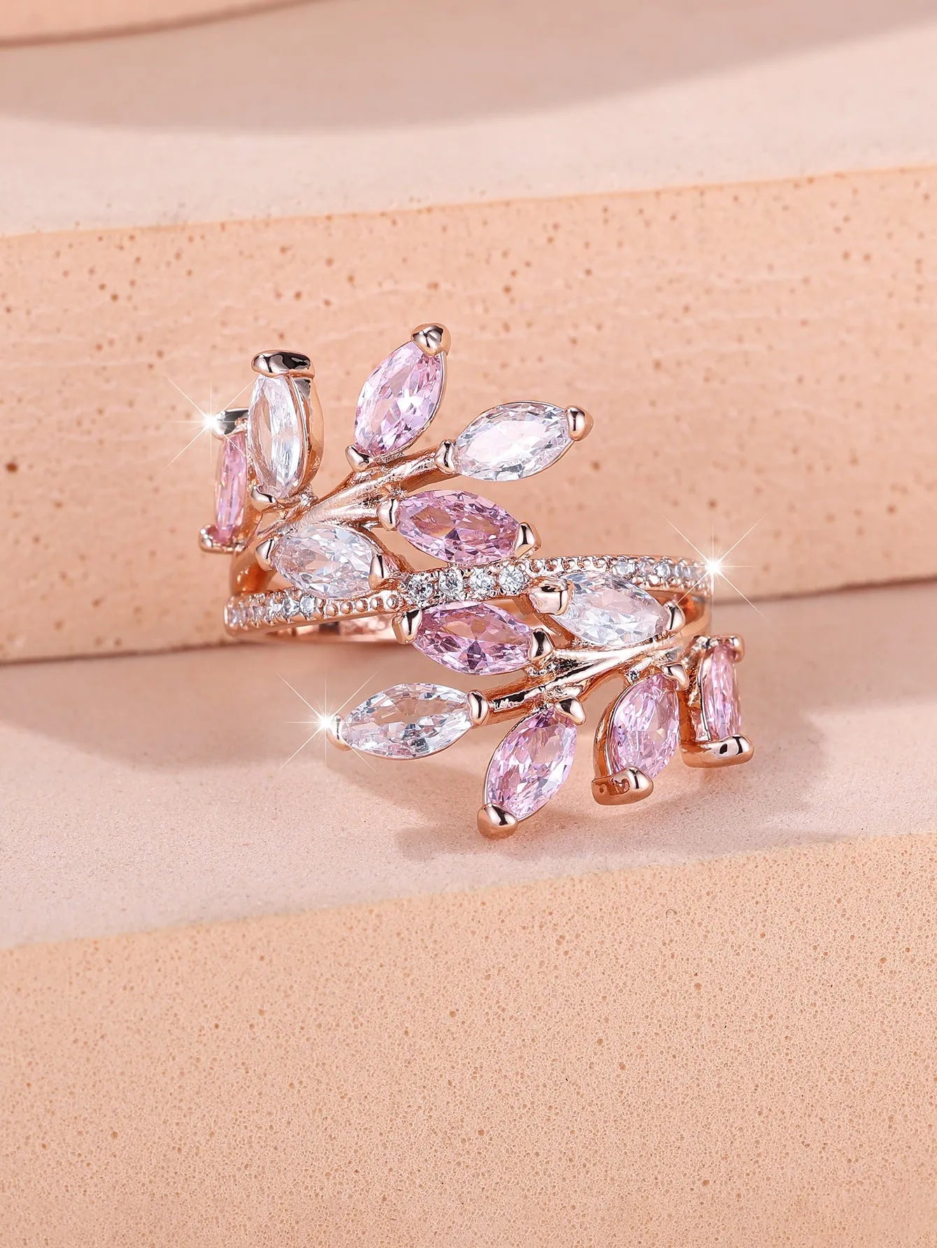 Adjustable copper leaf ring with a zircon stone in a choice of rose gold or platinum finishes.
