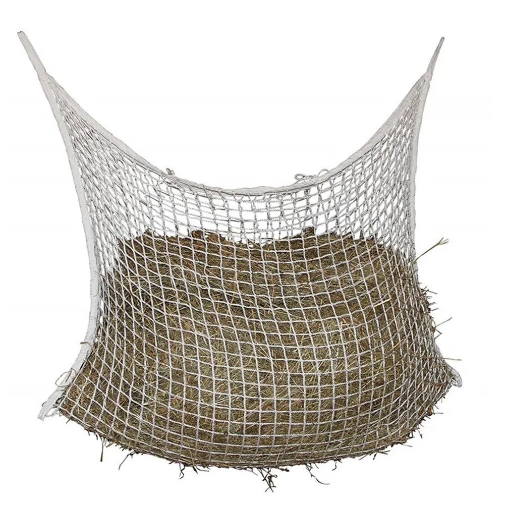 Black woven grid horse feeding bag hanging on a fence