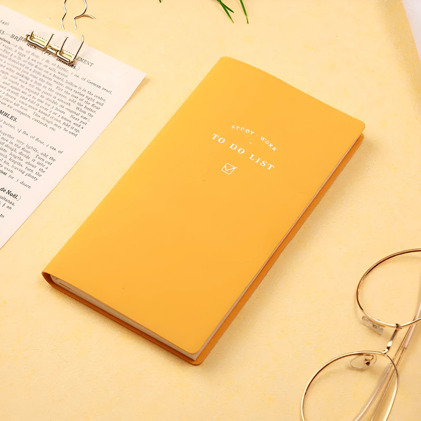 Simple Style 48K PU cover todolist notebook open on a desk, showing Macaron Yellow colour and lined writing paper.