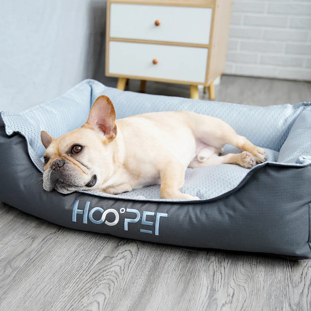 Soft grey dog bed with raised edges and a removable plush cover, shown in medium size.