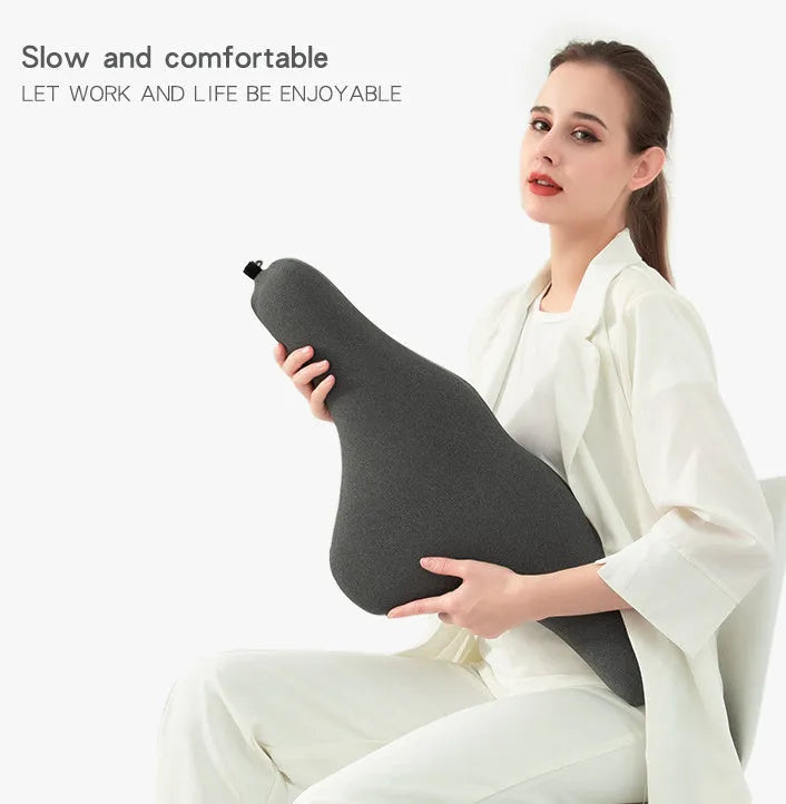 Dark gray memory foam car neck pillow on a car headrest.